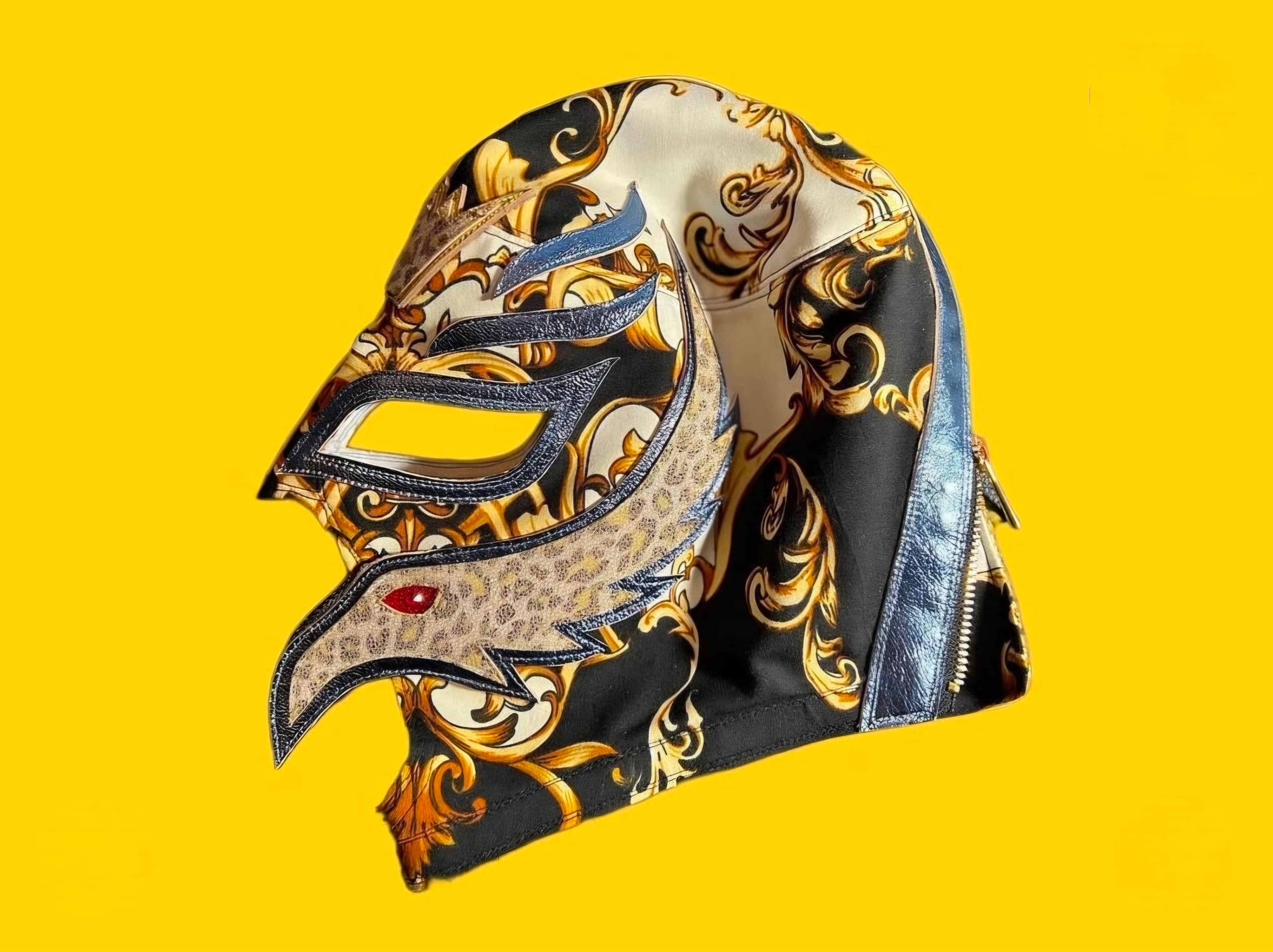 Decorative Lucha Libre mask featuring gold baroque patterns and an eagle profile on yellow.