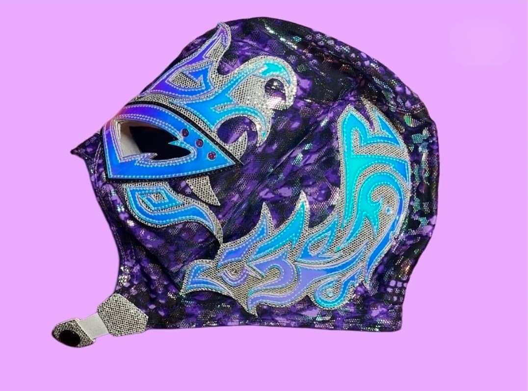 Intricate purple leopard print Lucha Libre mask with shimmering blue and silver flame-like patterns.